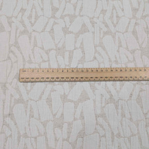 Textured fabric with a pattern and a ruler for scale on top. Available at Minerva's Bower