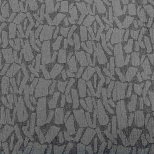 Patterned graphite muno jacquard fabric with abstract shapes on a grey background. Available at Minerva's Bower