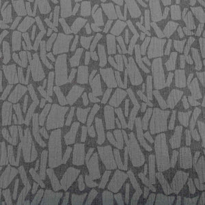 Patterned graphite muno jacquard fabric with abstract shapes on a grey background. Available at Minerva's Bower