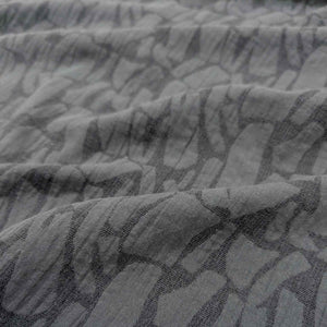 Close-up of graphite muno jacquard fabric with a subtle pattern. Available at Minerva's Bower