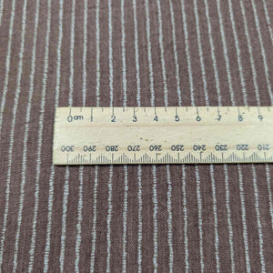 Brown fabric with white stripes and a wooden ruler for scale. Available at Minerva's Bower