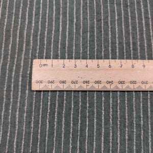 Textured fabric with a ruler for scale on a matching background. Available at Minerva's Bower