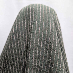 Close-up of a green fabric with white pinstripes on a white background. Available at Minerva's Bower