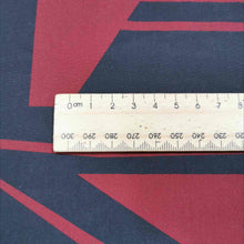 Load image into Gallery viewer, Metropolis is a dramatic, large scale graphic print. Pure cotton, with black on a claret red background, available at Minerva&#39;s Bower. Image includes a ruler for scale