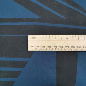 Metropolis is a dramatic, large scale graphic print. Pure cotton, with black on teal background, available at Minerva's Bower. Image includes a ruler for scale