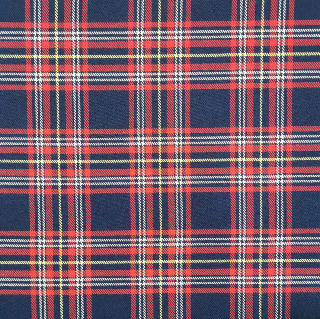 Chloe is a pure cotton tartan twill. A navy blue base, with lines of red, white and yellow, to create the plaid effect. Available at Minerva's Bower