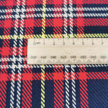 Load image into Gallery viewer, Chloe is a pure cotton tartan twill. A navy blue base, with lines of red, white and yellow, to create the plaid effect. Available at Minerva&#39;s Bower. Image includes a ruler for scale