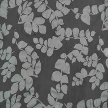 Load image into Gallery viewer, Liana is a drapey, lightweight, pure cotton voile, with the silhouette of foliage as a grey contrast on black background. Available at Minerva&#39;s Bower