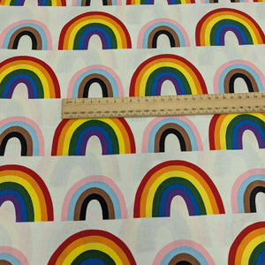 Alexander Henry cotton Fabric with rainbow pattern and a ruler for scale on a white background, for sale at Minerva's Bower