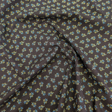 Load image into Gallery viewer, Drape of Japanese cotton fabric with a small floral pattern on a black base, for sale at Minerva&#39;s Bower