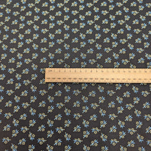 Load image into Gallery viewer, Japanese cotton fabric with a small floral pattern on a black base, with ruler included for scale, for sale at Minerva&#39;s Bower