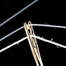 Load image into Gallery viewer, Close up of eye of clover self threading needle showing action of threading