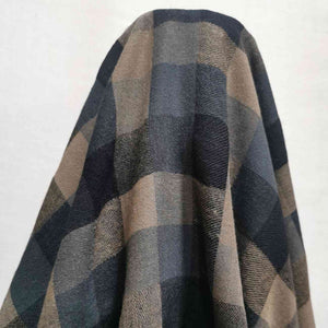 Shetland Check is a beautful yarn dyed linen cotton fabric. It is woven in tones of blues and taupe, and is available at Minerva's Bower. Fabric is draped over roll.