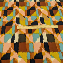 Load image into Gallery viewer, Multicolored geometric patterned rayon fabric with a ruler for scale, for sale at Minerva&#39;s Bower