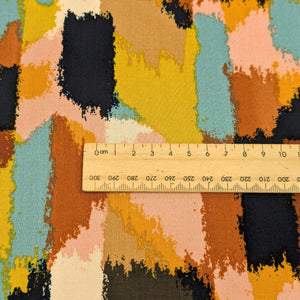 Colorful abstract patterned fabric with a ruler for scale