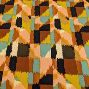 Multicoloured geometric patterned rayon fabric with shades of orange, black, green, and brown for sale at Minerva's Bower