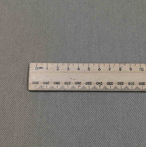 Flat lay of washed cotton drill in taupe colourway. Available at Minerva's Bower. Ruler included for scale