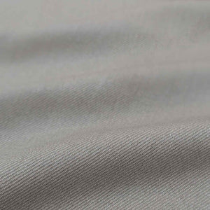 Flat lay of washed cotton drill in taupe colourway. Available at Minerva's Bower. Fabric draped to show how it handles