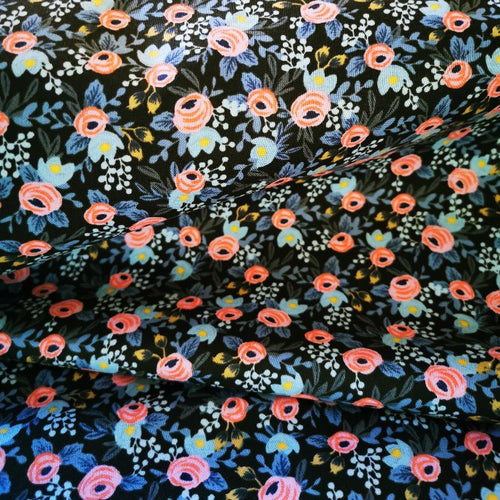 Black cotton covered with small flowers in pale pink, blues, white, green and yellow. Cotton and steel medium weight. 115cm wide.